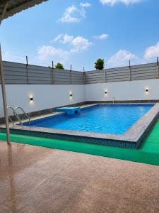 a swimming pool in a building with a large pool at Omkara Villa Sonipat in Sonīpat