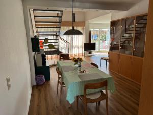 a dining room with a green table and chairs at Fewo Bad Salzuflen in Bad Salzuflen