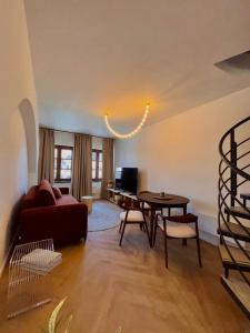 a living room with a couch and a table at Apartmán Thea in Komárno