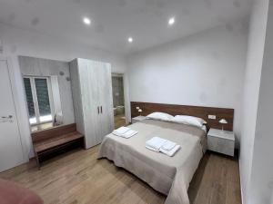 a bedroom with a bed with two towels on it at Les chambres de Nancy in Contursi Terme