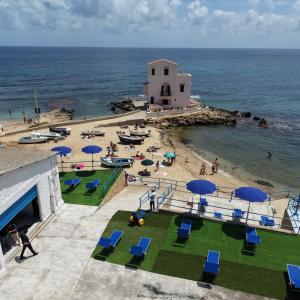 an aerial view of a beach with chairs and umbrellas at Las Palomas in Santa Flavia