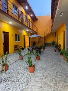 a courtyard with chairs and plants in a building at Hotel Santa Cecilia in Villa Corona