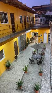 an outdoor patio with a table and an umbrella at Hotel Santa Cecilia in Villa Corona