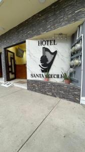 a hotel sign on the side of a building at Hotel Santa Cecilia in Villa Corona