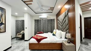 a bedroom with a large bed in a room at Standard Elite Palace inn Hotel in Islamabad