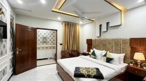 a bedroom with a large white bed in a room at Standard Elite Palace inn Hotel in Islamabad