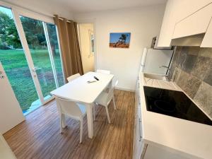 a kitchen with a white table and a white refrigerator at Masseria La Torre in Maglie +79 photos