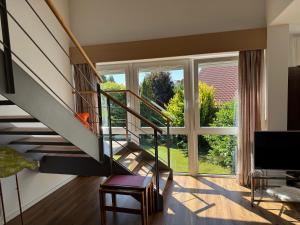 a living room with a staircase and a large window at Fewo Bad Salzuflen in Bad Salzuflen