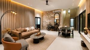 a living room with a couch and a table at Abu Rakan Apartment in Muscat