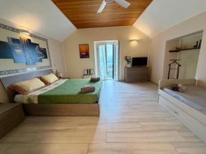 a bedroom with a bed and a television in it at Villa Silvana in Perledo