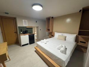 a bedroom with a large bed with towels on it at Divine Suites Tinos in Tinos