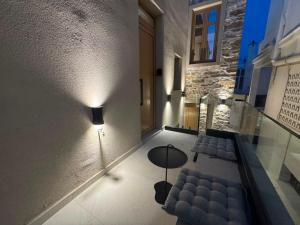a room with a couch and a table and a building at Divine Suites Tinos in Tinos