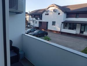 a balcony with a car parked in a parking lot at Vitez apartman in Vitez