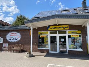 a store with solar panels on top of it at Deep Blue Dümmer - Apartment in Lembruch