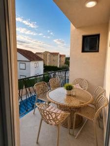 a patio with a table and chairs on a balcony at Apart-pool Tivat in Tivat