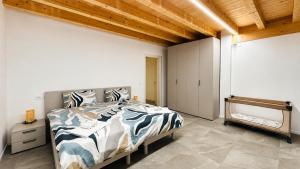 a bedroom with a bed and a wooden ceiling at Venice Easy Stay Meolo in Meolo