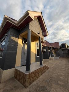 a house with pillars in front of it at HM Homes in Morogoro