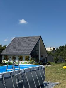 a house with a swimming pool in front of it at Yellow House Natakhtari in Mtskheta