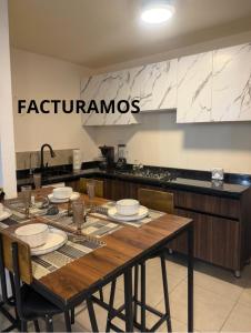 a kitchen with a wooden table with plates on it at Executive Apartment for 6 people in El Colorado