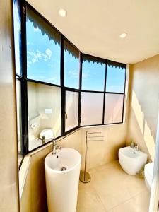 a bathroom with a sink and a toilet and a window at Augusta e Libero Apartments in Spoleto +10 photos