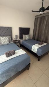 a bedroom with two beds and a ceiling fan at Executive Apartment for 6 people in El Colorado