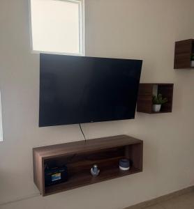 a flat screen tv hanging on a wall at Executive Apartment for 6 people in El Colorado