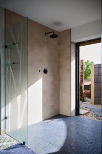 a glass door in a room with a wall at Wish You Were Here! in Wilderness