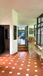 a room with a red tile floor in a house at Entre Pajaros y Flores in Rivera