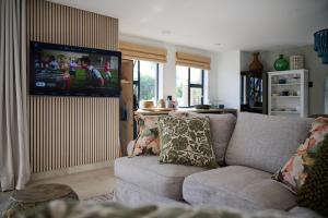 a living room with a couch and a flat screen tv at Wish You Were Here! in Wilderness