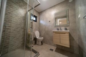 a bathroom with a shower and a toilet and a sink at Wine House Churilo in Ohrid +55 photos