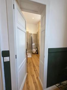 an open door to a bathroom with a toilet at Villa Aestival in Saint-Symphorien