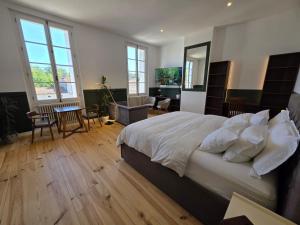 a bedroom with a large bed and a table and chairs at Villa Aestival in Saint-Symphorien +41 photos