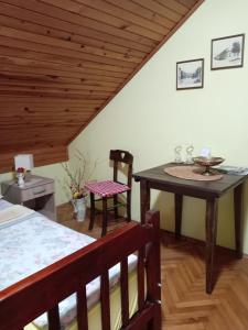 a room with a bed and a table and a chair at Putnicka kuca kod Dragane in Bajina Bašta +29 photos