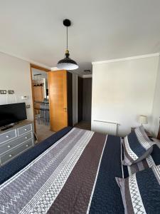 a bedroom with a large bed and a television at La mejor terraza en el centro de Viña del Mar, cerca de todo in Viña del Mar +34 photos