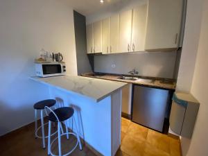 a kitchen with two bar stools and a counter top at Apartment with private balcony in San Javier