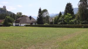a house in a field with a large yard at Glöcknerhaus in Sankt Gallen +5 photos