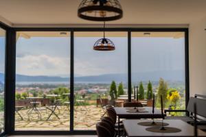 a dining room with a view of a patio at Wine House Churilo in Ohrid
