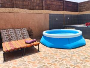 a chair and a large tub in a room at Antic house in Agadir