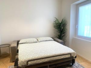 a bed sitting in a room next to a window at Le Port Vieux in Pesaro