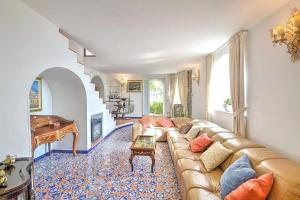 a living room with a couch and a piano at Villa Borgo San Michele in Amalfi