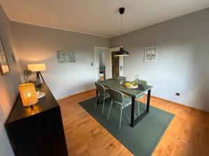 a living room with a dining room table and chairs at Landblick Halver - Ferienwohnung mit Balkon in Halver +9 photos