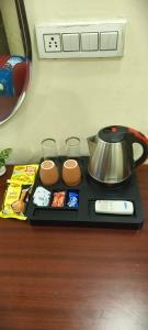 a tray with a tea kettle and some food at The duggar villa in Jammu +10 photos