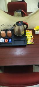 a tea kettle on a tray on a table at The duggar villa in Jammu