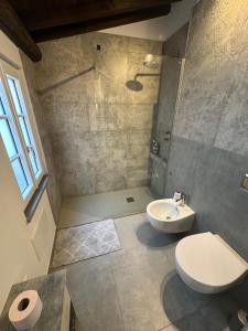 a bathroom with a shower and a toilet and a sink at Casa Michele in Pontremoli