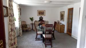 a dining room with a table and chairs at The Post Office, 6 beds, Bar, Library, Pool Table, Stream, Large Garden in Piddletrenthide