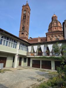 a building with a clock tower in the background at Zia Rina in Bra