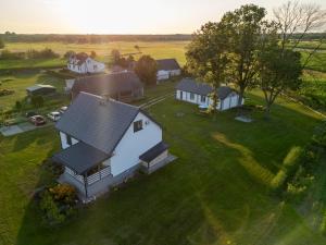 an overhead view of a white house on a green field at Ostoja Tatary Agroturystyka in Tykocin