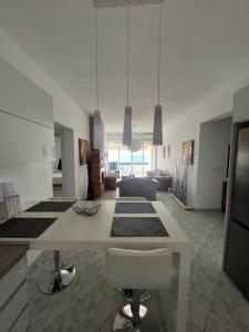 a kitchen with a white counter and a living room at Paradise House in Lefkandi Chalkidas