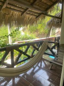 a hammock on the porch of a resort at Villa del Mar in Zipolite