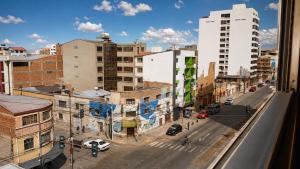 a view from a window of a city street with buildings at Hotel Beirut Oruro in Oruro